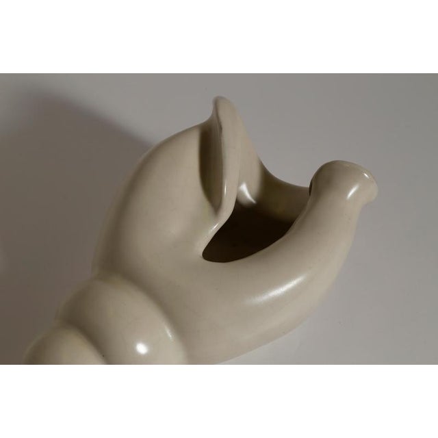 A sculptural shell vase by c.h. Brannam, barnstaple, england, dating to approximately 1965. Modelled as an elongated...