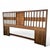 A king-size headboard with richly grained walnut veneer, polished chrome trim, clean horizontal lines and a subtle...