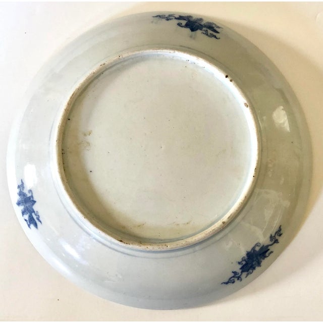 Unusual 19th C. Imari Japanese plate with a central floral banded medallion which pairs of asymmetrical blue swirls and...