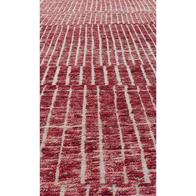 Measures: 4'7 x 11'7. This modern casual tribal Moroccan rug has been hand-knotted in wool. The rug features a modern...