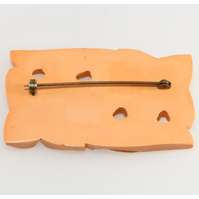 This is part of Chairish’s Costume Jewelry assortment. Carved brooch made of yellow Bakelite with beautifully executed...