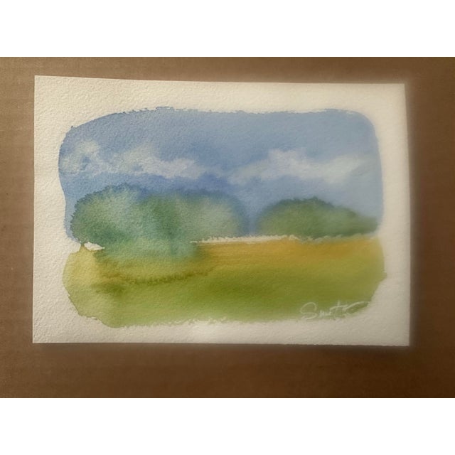 A complementary pair of original watercolor landscape studies featuring soft horizons, gentle skies, and rolling green...