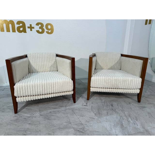 These 1970s lounge chairs blend sculptural form with plush comfort. The angular wooden frames feature elegant lines and...