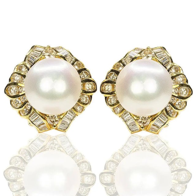 18k Earrings with two 9.7mm South Sea Pearls and 44 round and 28 baguette diamonds weighing approximately 1.50 carats....