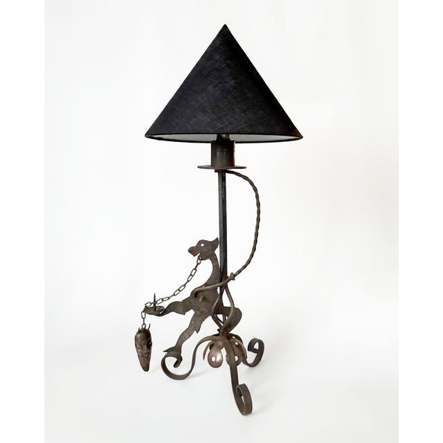 Hand forged dragon lamp with candleholder and devil head snuffer ca. 1910. Measures 18" tall, shade not included.