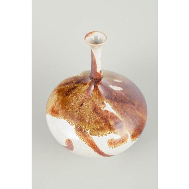 Isak Isaksson Unique vase, late 20th century. Wheel-thrown stoneware vase with tall slender neck and organic brown flowing...