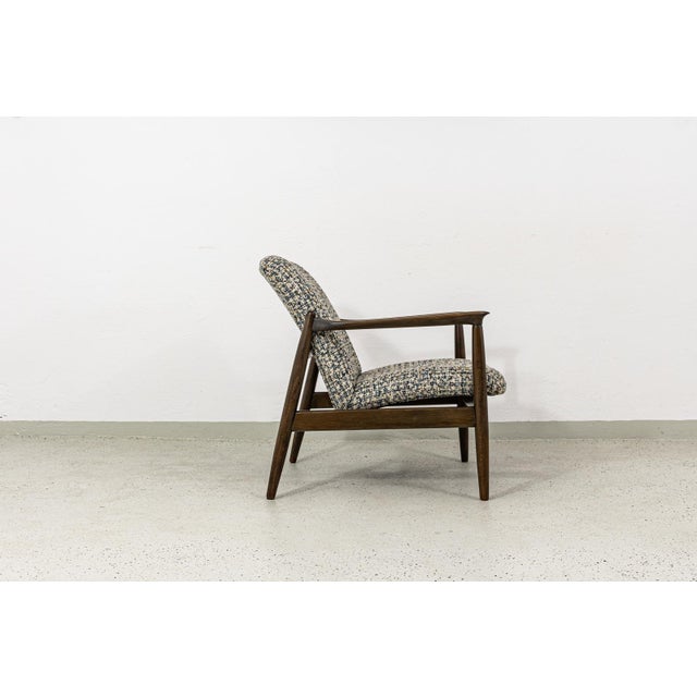 A vintage GFM-64 armchair designed by Edmund Homa, produced by the Gościcińska Fabryka Mebli (GFM) in Poland during the...