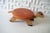 This listing is for a 1960s vintage, handmade wooden turtle footstool. It features an burnt orange "faux leather" vinyl...