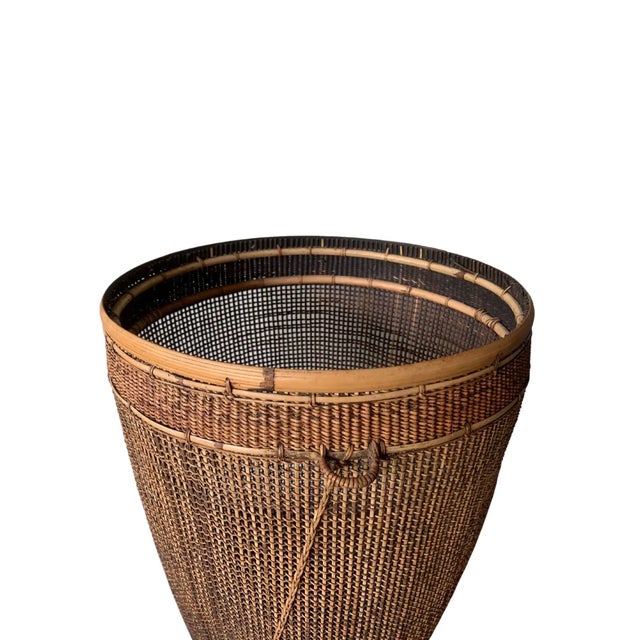 This mid-20th century hand-woven basket originates from the Dayak tribe of Borneo crafted with bamboo & rattan fibres. The...