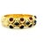 Substantial 18K gold bangle bracelet featuring a bold arrangement of cabochon rubies and sapphires set across a flexible,...