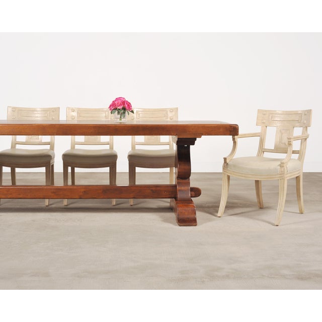 An imposing 20th century Country French Provincial style farmhouse dining table crafted from oak. The table features a...