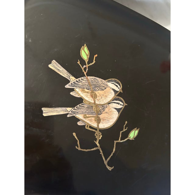 This is a mid century modern vintage Couroc tray of Monterey. It features an inlaid bird design of two birds perching on a...
