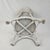 Charming vintage white wicker planter stand featuring a decorative woven design and convenient lower shelf for added...