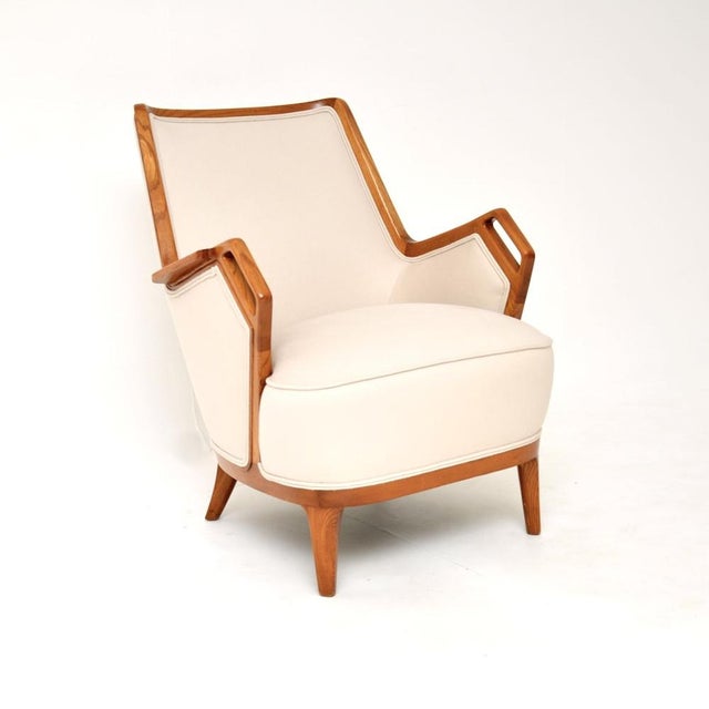 An outstanding vintage Swedish Elm armchair with a very stylish and unusual design. This was recently imported from...