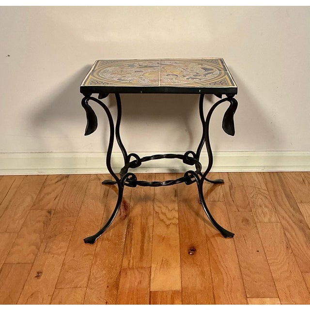 This is a true wrought iron side/accent table with hand-painted pottery tile top by Addison Mizner (1872-1933) a premier...