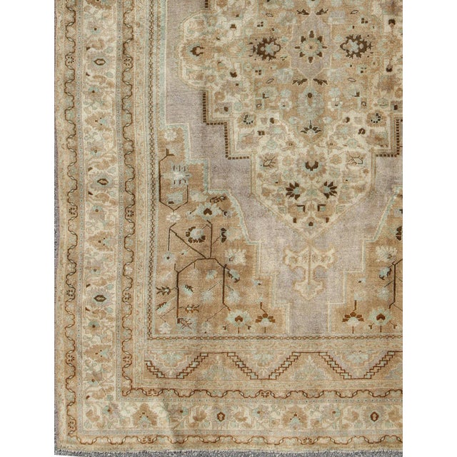 Measures: 7'2 x 11'0 This stunning vintage Turkish Oushak carpet (circa mid-20th century) features a central medallion...