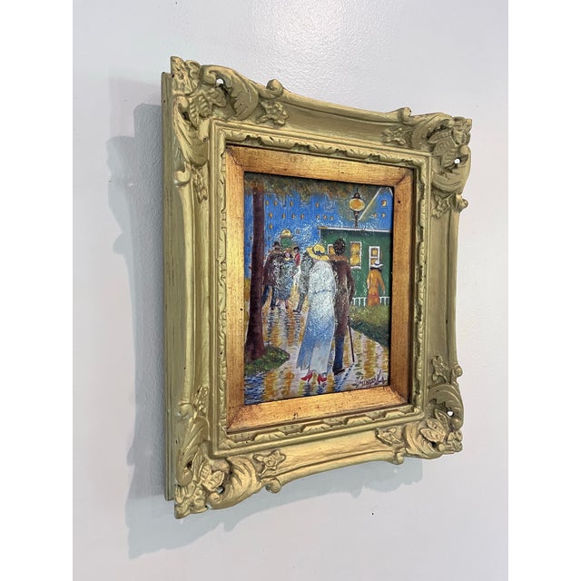 A charming vintage hand-painted enamel on copper plaque depicting an elegant rainy evening promenade illuminated by...