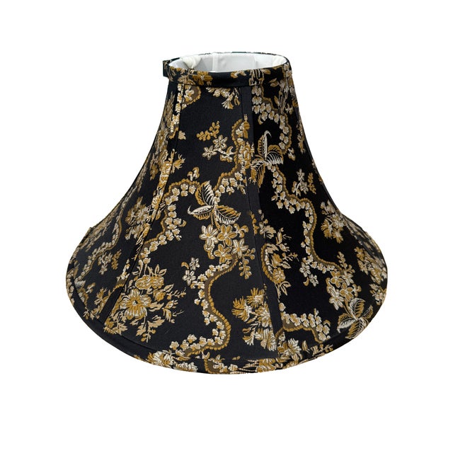Elegant pagoda-style lamp shade in black and gold chinoiserie fabric, with a dramatic flared silhouette and architectural...
