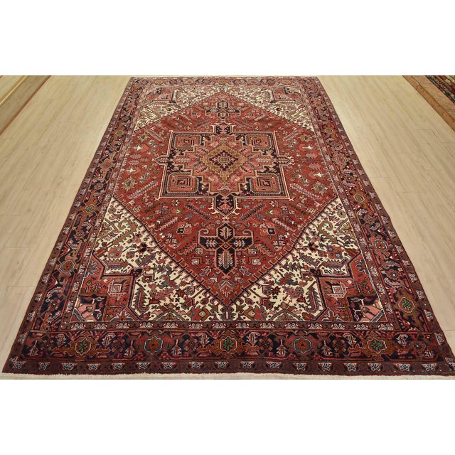 An authentic vintage traditional tribal Heriz rug hand-knotted with fine wool and natural dyes. This rug features a...