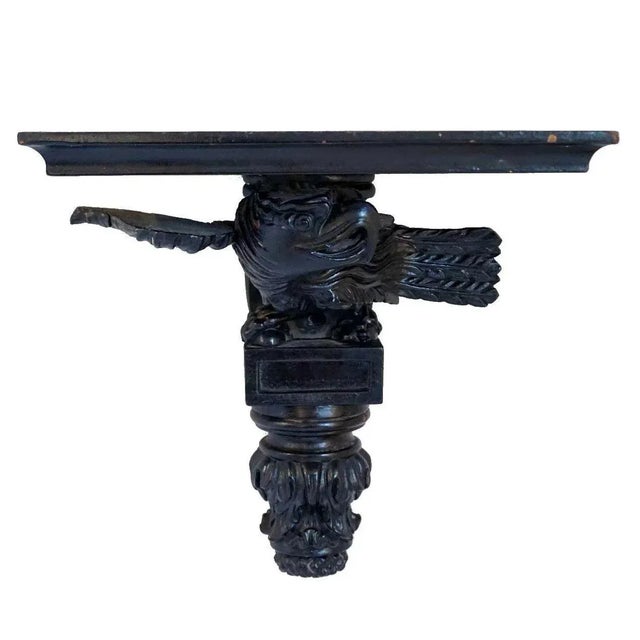 DETAILS This antique black lacquered bracket features a rectangular shelf above a very stylized, hand carved eagle. He...