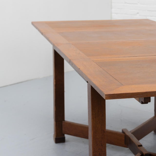 Dutch Art Deco dining table in the manner of the Hague School, dating from circa 1930 and executed in oak. The table has a...