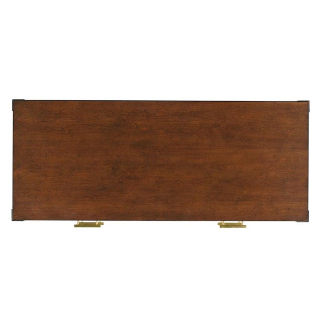 A rectangle top rests over squared corner posts flanking three individual drawers over an "X" base.