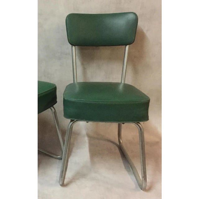 This set of six desk chairs from the 1950s are made of green bottle colored skai with chromed steel bases.