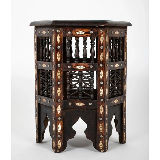 Moroccan six sided glass topped side table with incised bone inlay and nail heads, and signature decorative turned wood...
