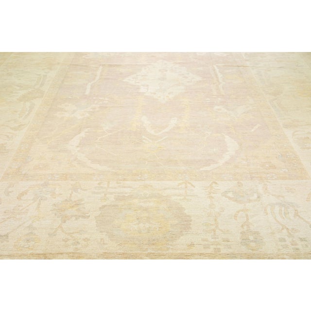 Beautiful contemporary Oushak hand-knotted wool rug with a beige field. This Oushak rug has a scattered brown and gray...
