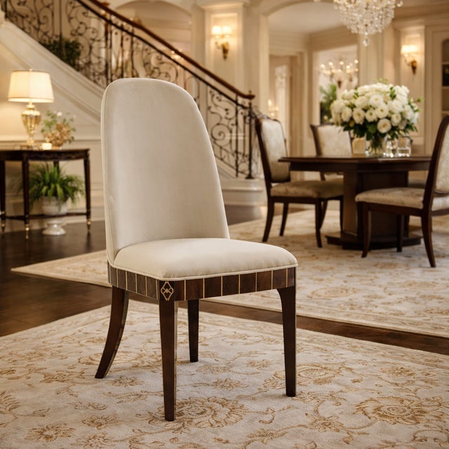 An elegant statement chair that brings refined warmth and sophistication to any dining room. This beautifully detailed...