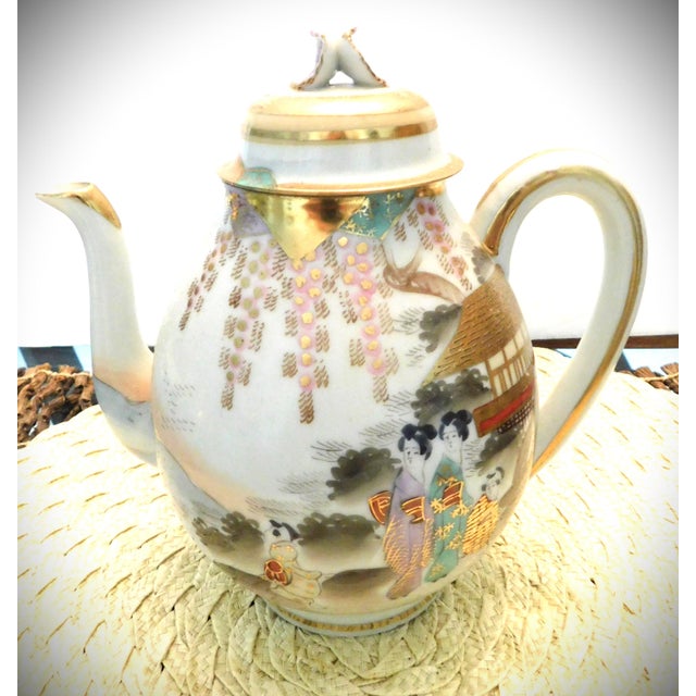 This 1940's three piece Japanese Kutani Porcelain Tea Service is composed of a tea pot, sugar and creamer all exquisitely...