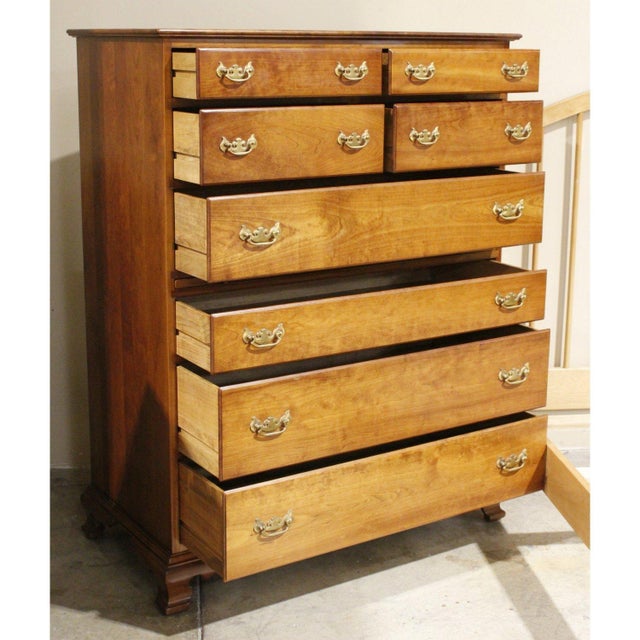 This piece features a classic colonial silhouette with a tall, balanced frame and gently curved feet. The eight‑drawer...