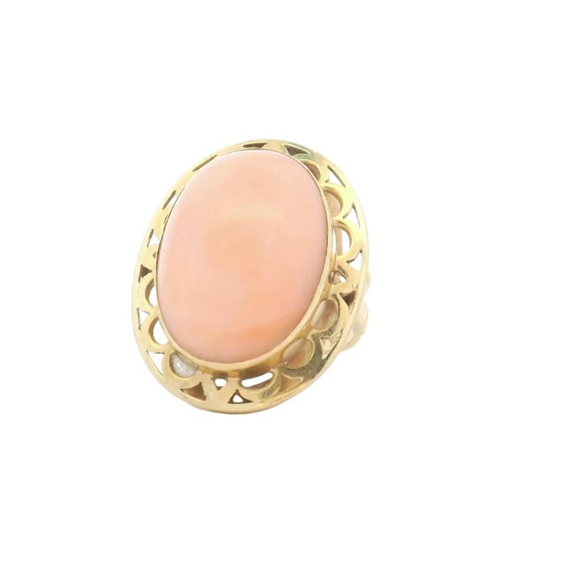A timeless vintage Italian ring showcasing the soft elegance of natural Angel Skin coral. Crafted in 14 karat yellow gold,...