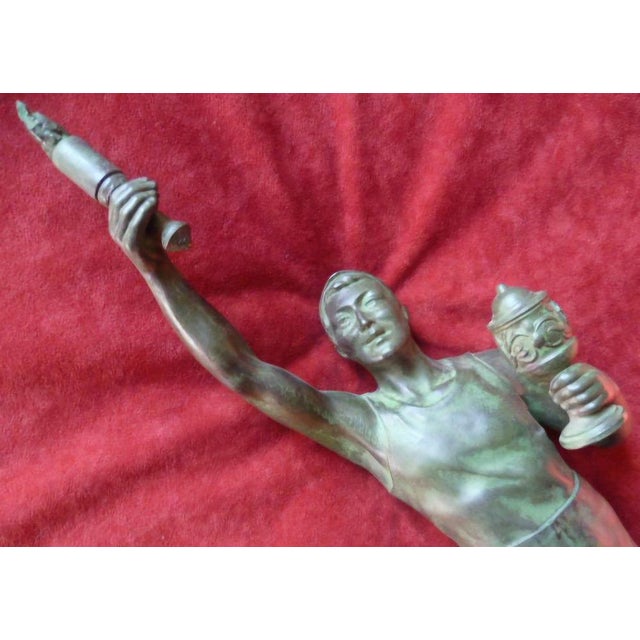 Rare original bronze commemorative trophy figure from the 1936 Berlin Olympic Games. The dynamic male athlete is depicted...