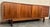 Danish modern server featuring sliding doors, dovetail joinery, and sculpted pulls. Six pull-out drawers and two rows of...