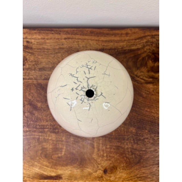 A beautifully understated American studio pottery bud vase by Andy Smith, dated 2006. Featuring a sculptural spherical...