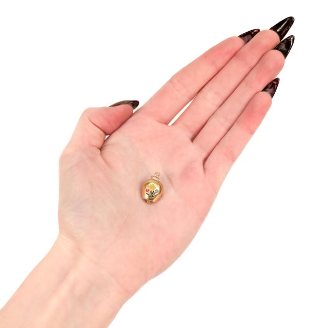 A fine vintage gold and enamel charm. In 18 karat yellow gold. In the form of a Swiss Treicheln or Trychlen cowbell. One...