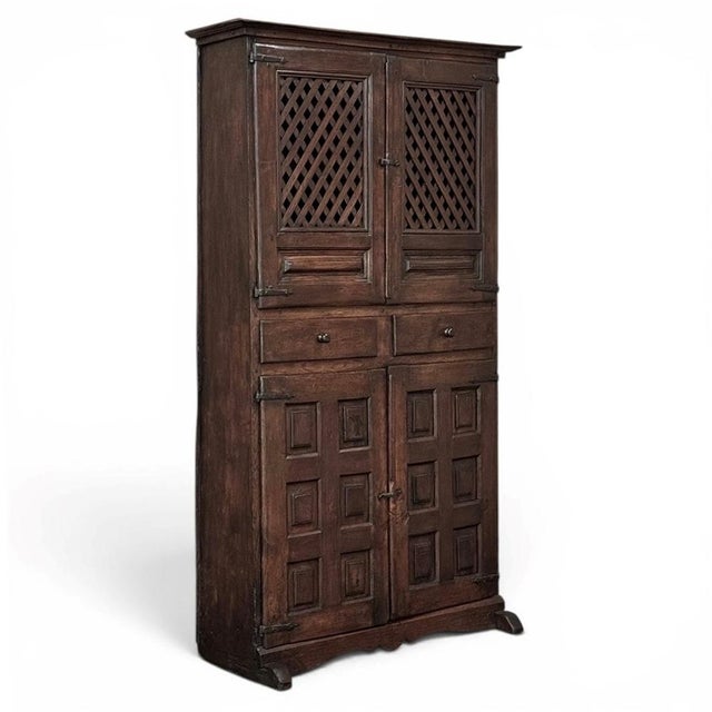 Warm Spanish walnut gives this 18th century cabinet a depth and presence that speak beautifully of age, use, and regional...