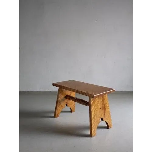 Carved low stool made of solid Karelian birch wood.