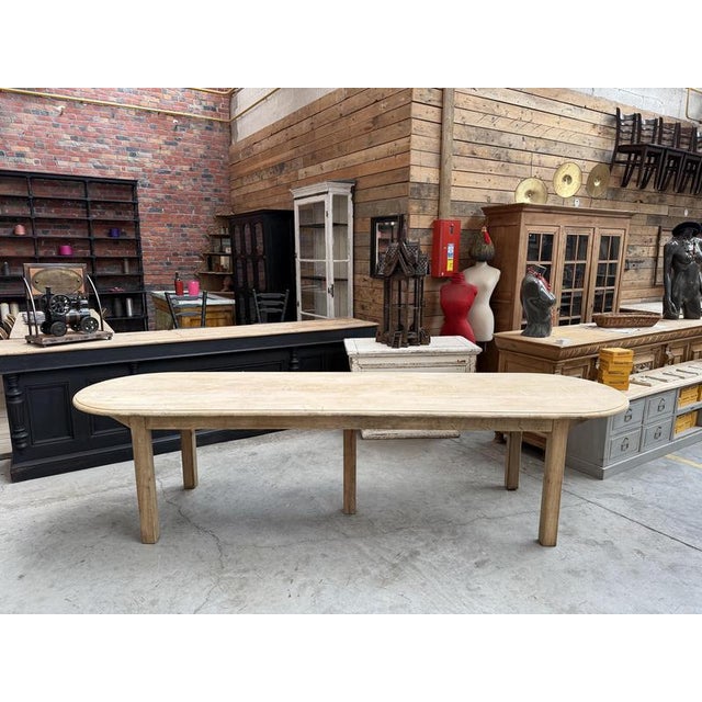 This immense oak communal table has been fully restored. It consists of a very large oval top and a base made up of four...