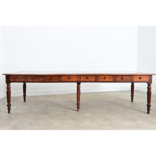 A substantial solid oak dining table from a French convent dating to the 1800s. The long, solid oak planks forming the top...