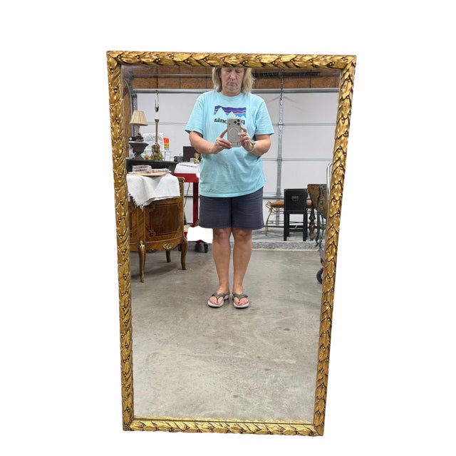 Vintage gold carved leaf and berries wall mirror. Wires are attached for horizontal or vertical hanging. Measures 46” x...
