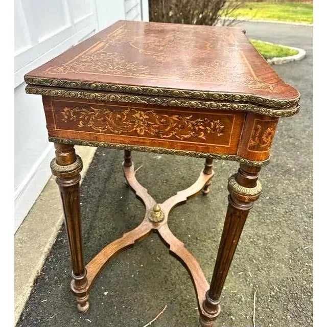 Antique French Inlaid Game Table With Green Felt has beautiful gold gilded designs. Has the capability of opening up into...