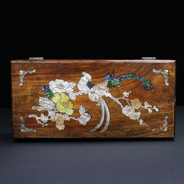 A beautifully crafted Chinese rectangular box, likely made of Huali (rosewood). The box features a hinged lid with brass...