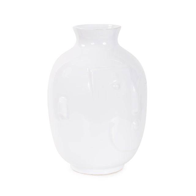 Featuring a stylized abstract face in a glossy white ceramic finish. Whether used to showcase fresh florals or styled as a...