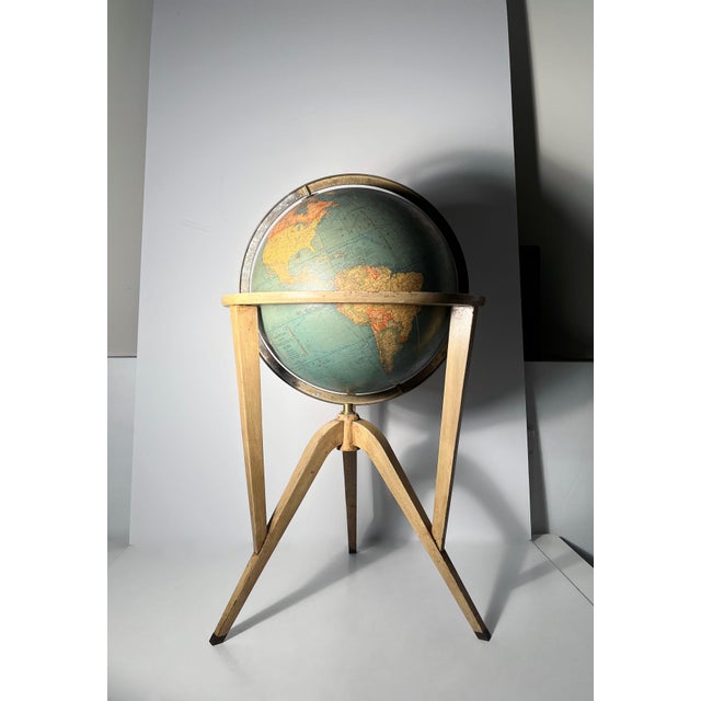 Rand McNally Globe by Edward Wormley / Dunbar A Tri-Leg Atomic design with Brass Capped Feet. This globe does not...