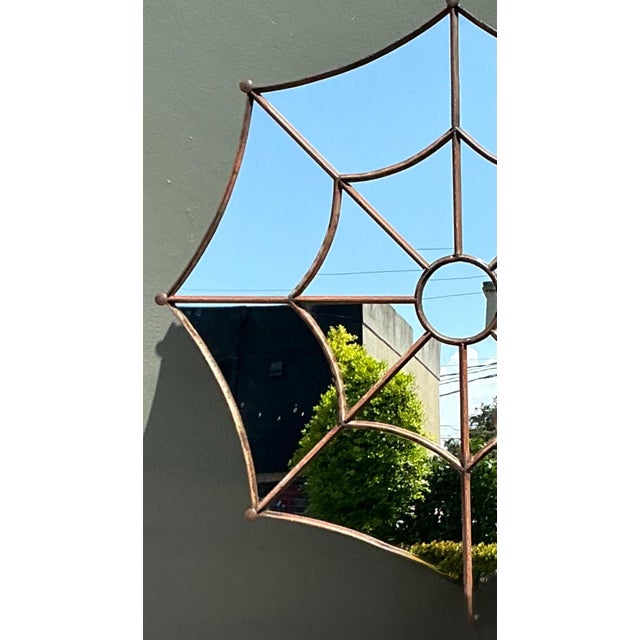 This exceptional vintage wrought iron mirror is a stunning display of mid-century architectural design, skillfully shaped...