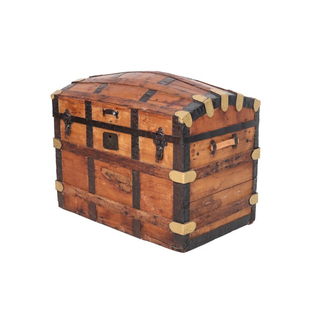 An antique barrel-stave steamer trunk dating from the mid 19th century. Made of oak, it has a domed lid with gold painted...