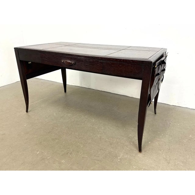 Campaign-style writing desk designed by Eric Brand for the Mulholland Brothers Home Collection. Features a dark wood...