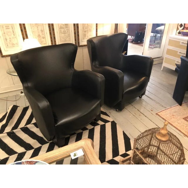 Striking sophisticated pair of iconic Milo Baughman for Thayer Coggin black leatherette club chairs having subtle quilting...